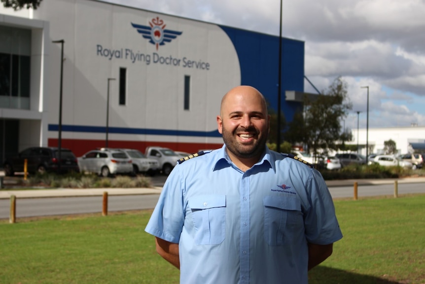 A man in an RFDS uniform smiles at the camera.