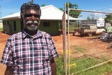 Charlie Nikunu Yunupingu in front of his almost completed home, one year after Cyclone Lam hit Elcho Island.