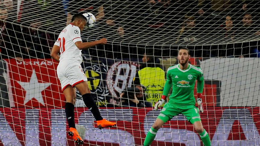 Sevilla's Luis Muriel heads the ball towards goal with Manchester United David De Gea watching.