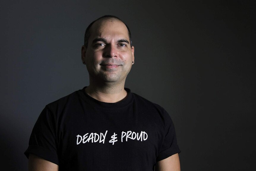 A portrait of Ben Graetz in a black t-shirt that says 'Deadly and Proud'.