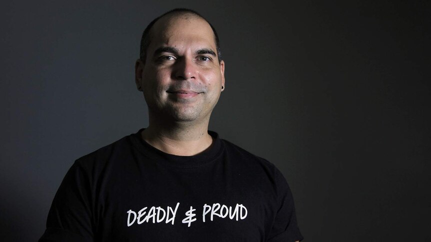 A portrait of Ben Graetz in a black t-shirt that says 'Deadly and Proud'.