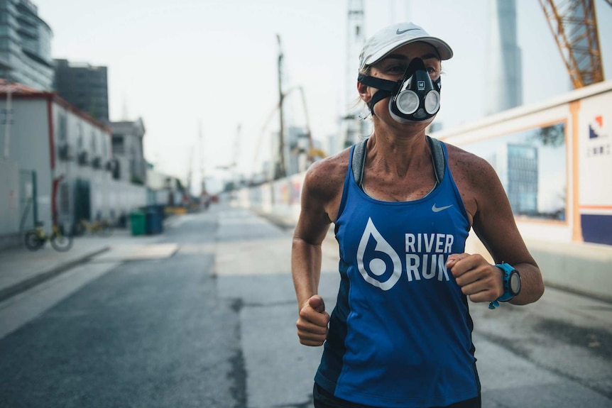 Marathon runner Mina Guli wears a face mask while running through Shanghai.