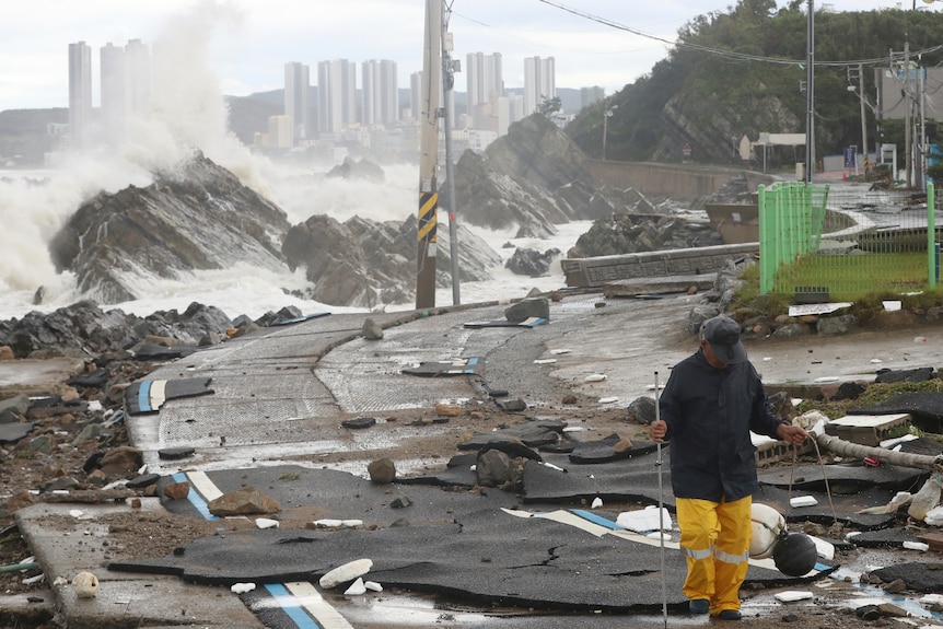 A road is damaged as waves hit a shore in Ulsan, South Korea