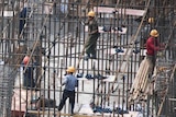 A Chinese construction site with workers pouring concrete