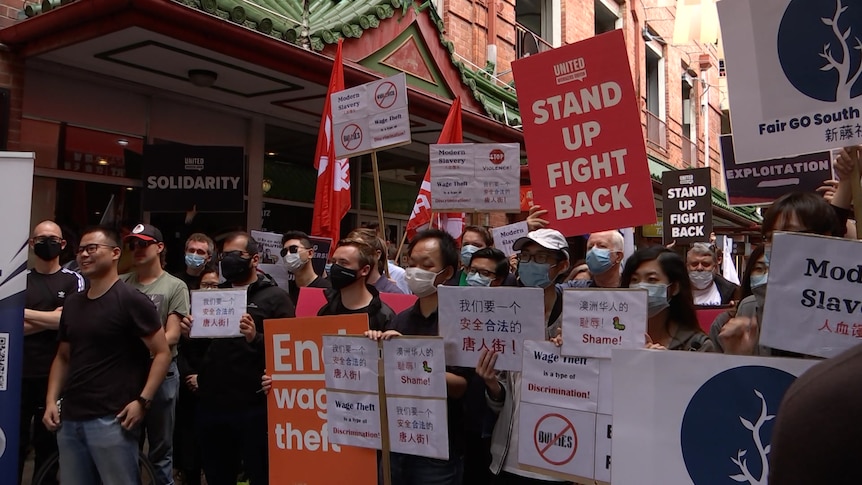 A group of protesters holding signs