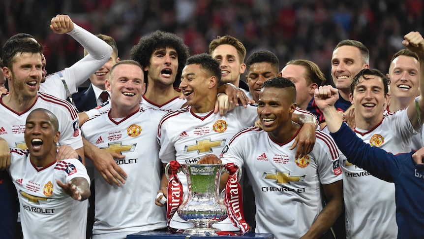 Manchester United players celebrate with the trophy after beating Crystal Palace in FA Cup final.