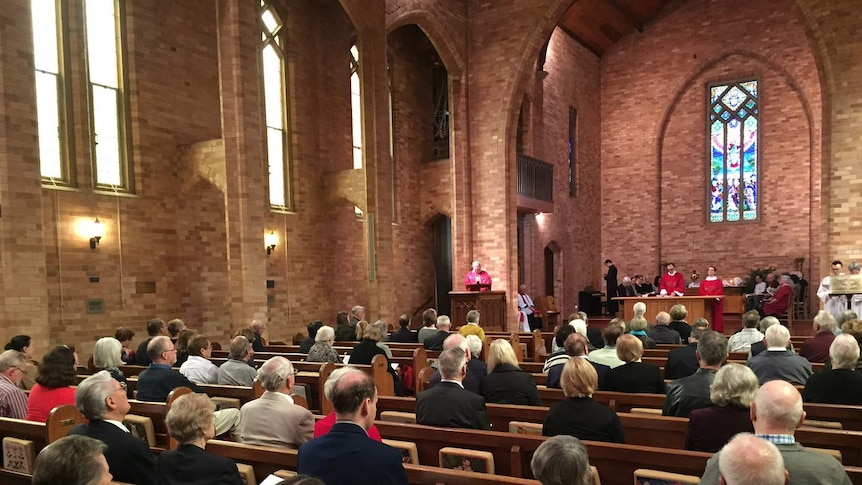 Worshippers gather for the Good Friday service St Paul's Anglican Church at Manuka in Canberra.