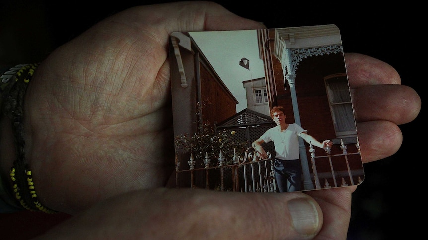 Fabian LoSchiavo's hand, holding an archival photo of himself (c. 1978).