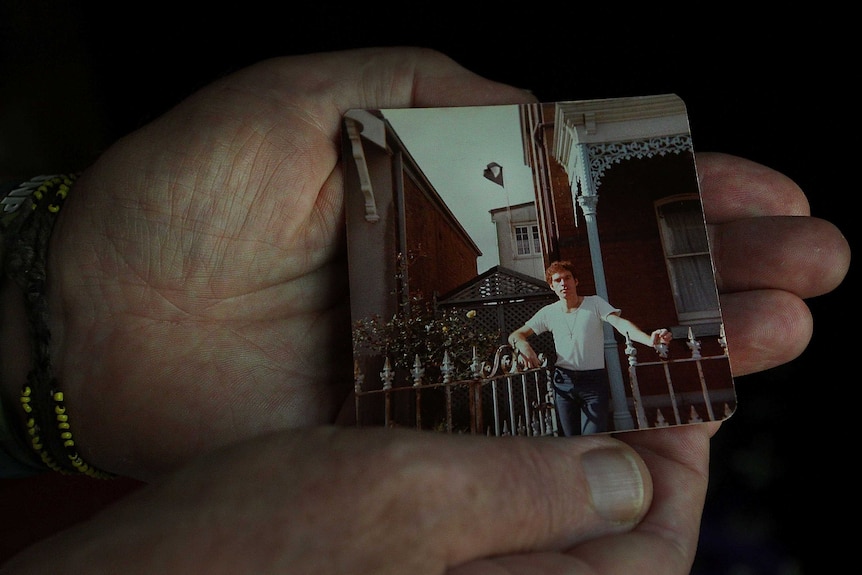 Fabian LoSchiavo's hand, holding an archival photo of himself (c. 1978).