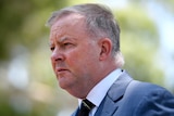 A close up shot of Anthony Albanese looking away from the camera, with a concerned expression.