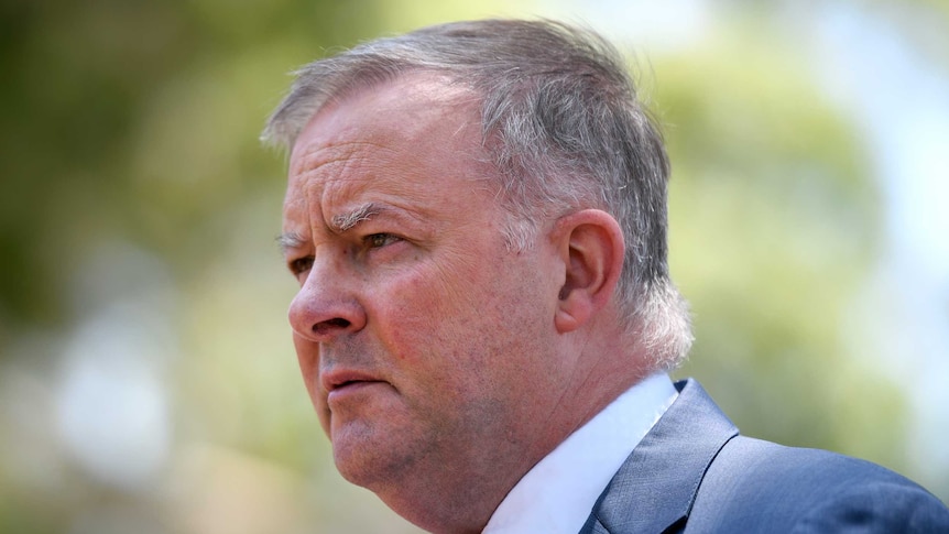 A close up shot of Anthony Albanese looking away from the camera, with a concerned expression.