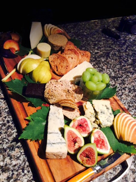 Fruit board with figs, cheese, pears, grapes
