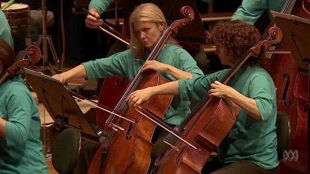 Women play cellos in orchestra