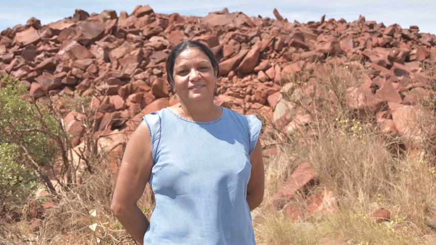 woman standing in front of rocks