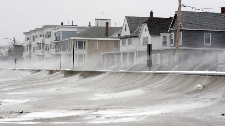 Snow blown off beach onto houses