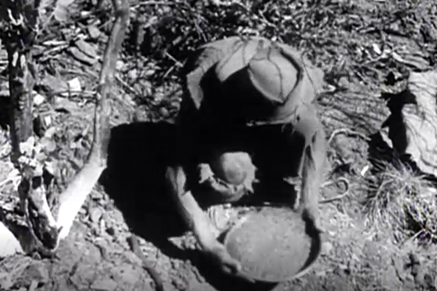 old picture of a man panning for gold 