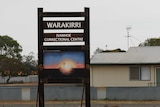 A sign reading 'WARAKIRRI IVANHOE CORRECTIONAL CENTRE' with a colourful Indigenous artwork underneath.