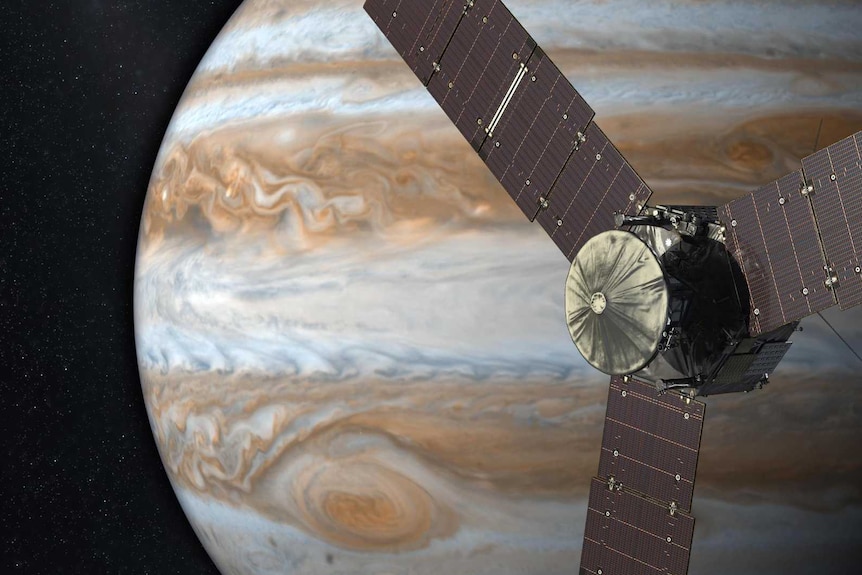 Artist's concept of NASA's Juno spacecraft with the gas giant Jupiter in the background