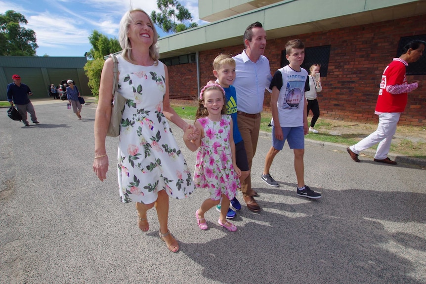 Marck McGowan walking with his wife and three children.