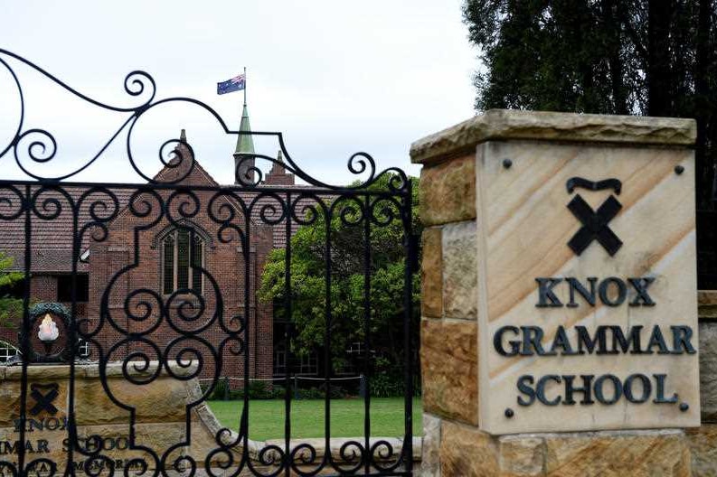 The front of Knox Grammar School with a metal gate and sign