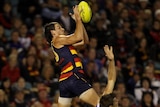 Taylor Walker takes to the air in the Crows forward line.