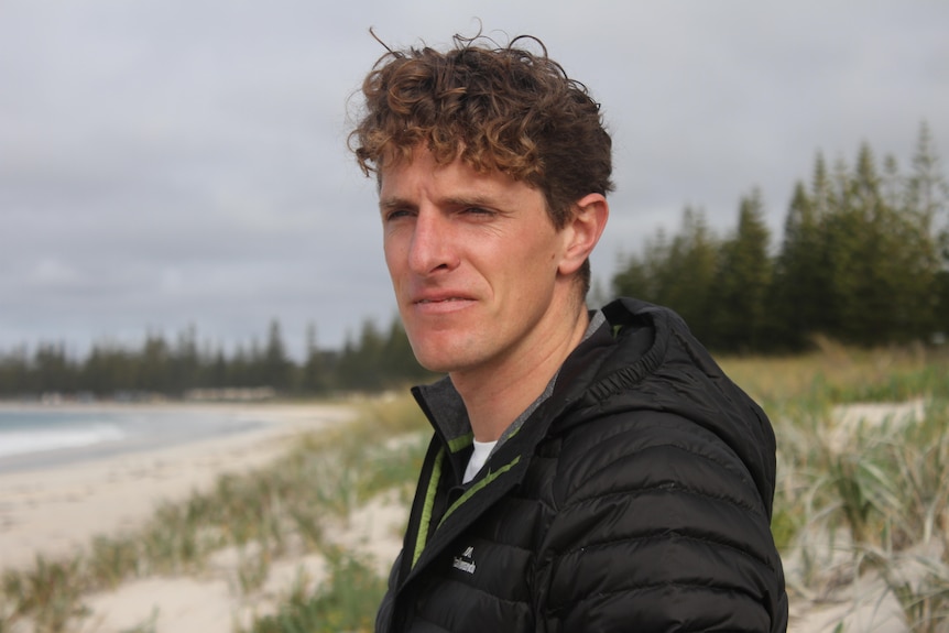 A man looking out over the beach.