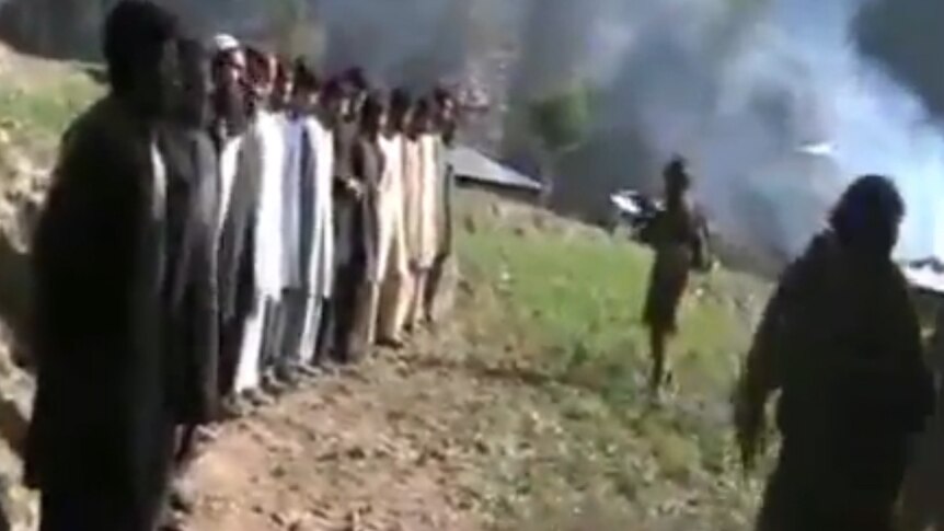 A video still shows a line of Pakistani policemen moments before they are executed by the Taliban.