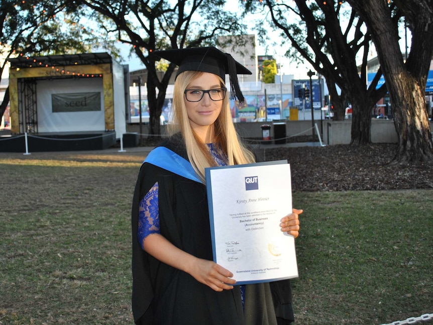 A photograph of accountant Kirsty Hinner holding her CPA accreditation