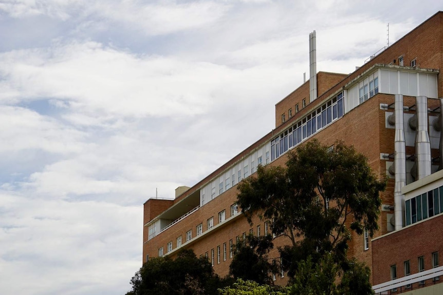 A brown-brick Royal Perth Hospital tower.