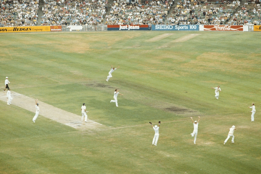 English fielders jump and run in celebration as the last Australian batter is dismissed in the 1982 MCG Ashes Test.