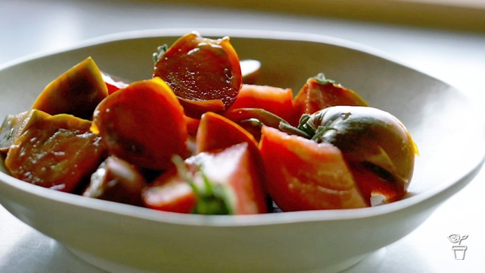 Bowl filled with cut tomatoes.
