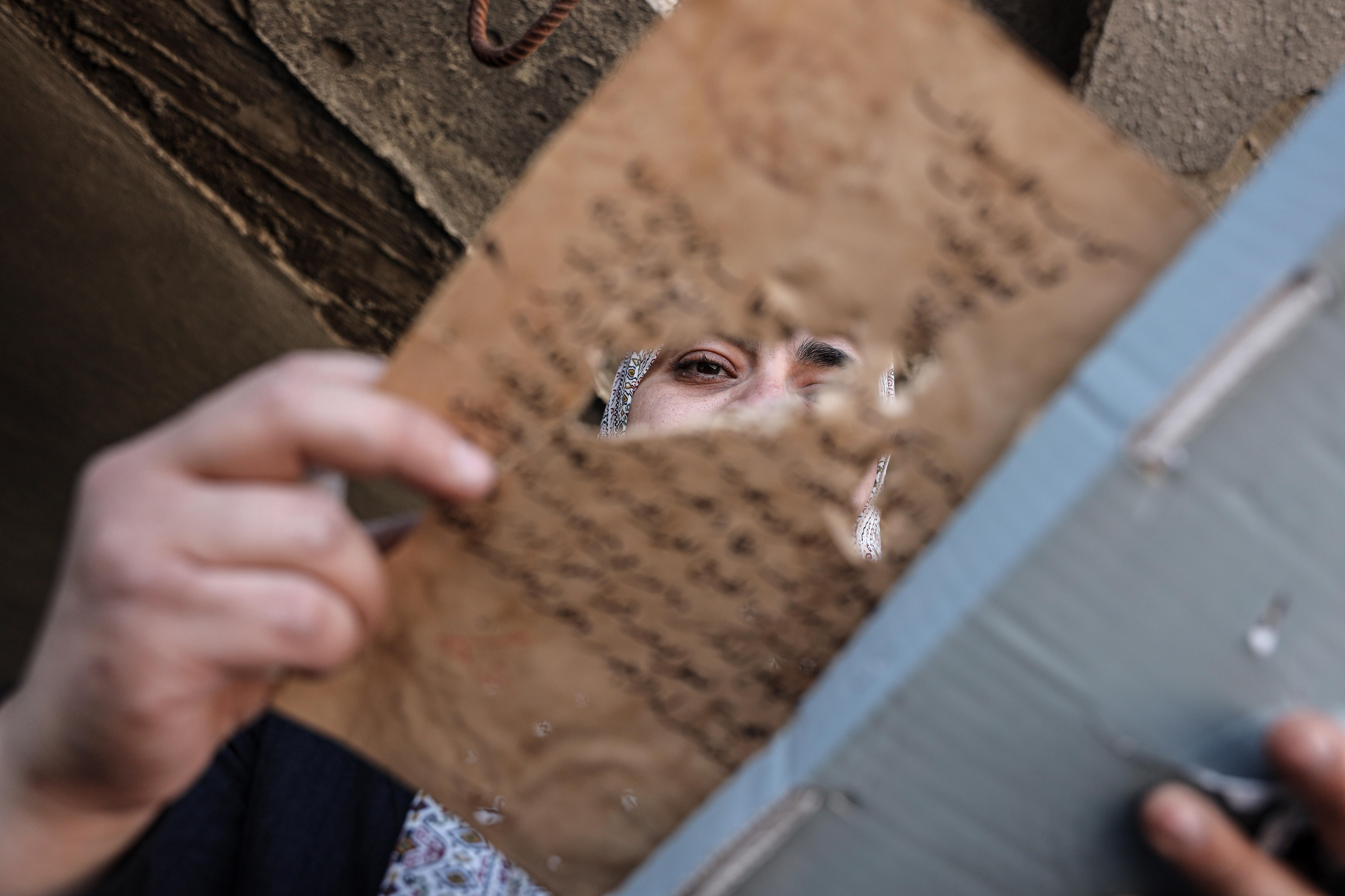 An archaeologist looks at a damaged manuscript.