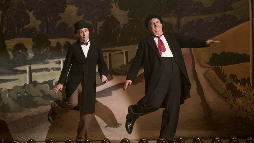 Colour still of Steve Coogan and John C. Reilly on stage in 2018 film Stan and Ollie.