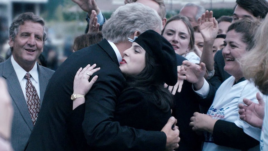 Beanie Feldstein as Monica Lewinsky embraces Clive Owen's Bill Clinton in a scene from American Crime Story: Impeachment