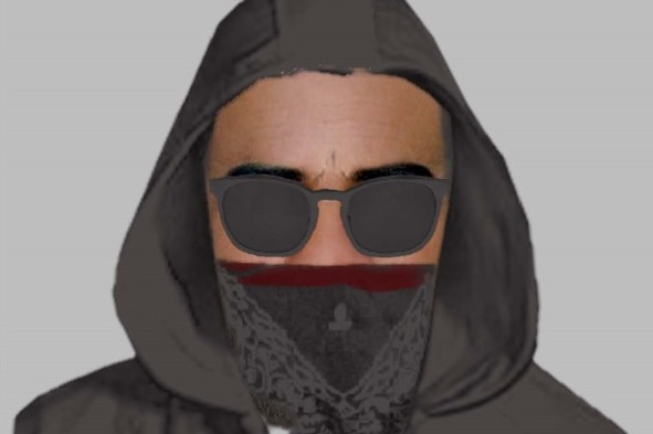 A man wearing a hood and glasses and face mask.