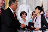 Aung San Suu Kyi (C) is presented with the Congressional Gold Medal by John Boehner.