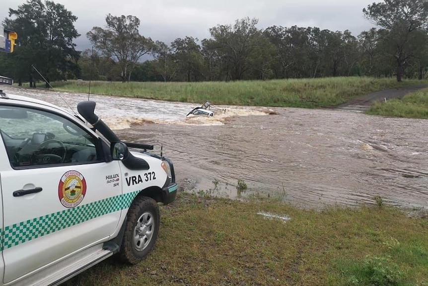 A ute washed into flood waters