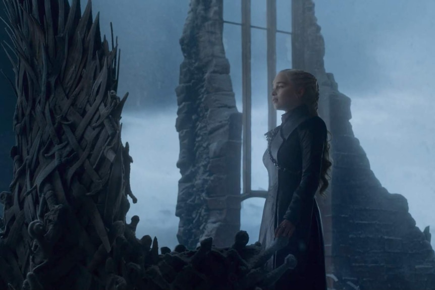 Daenerys touches the Iron Throne.