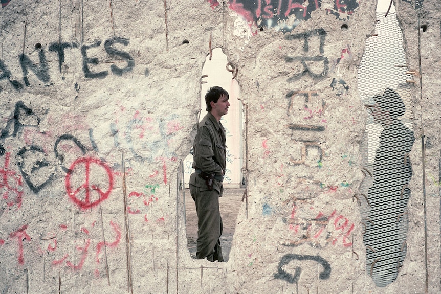 East German Soldiers Seen Through The Berlin Wall