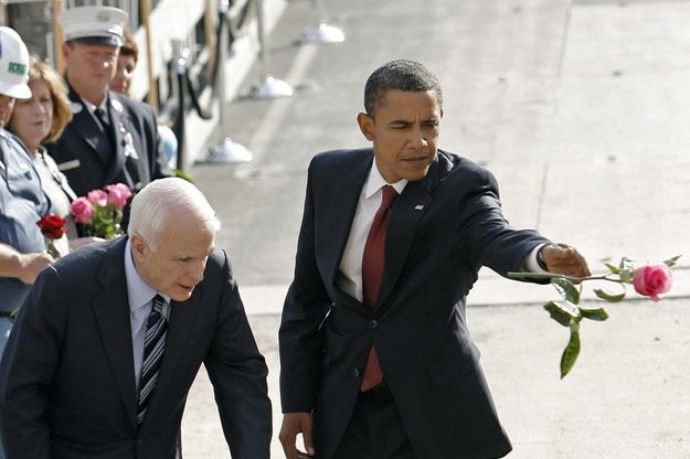 John McCain and Barack Obama toss flowers into the reflecting pool at Ground Zero