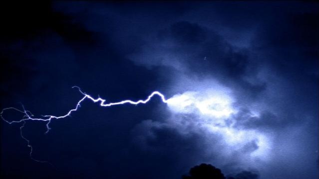 Bolt of lightning in sky at night