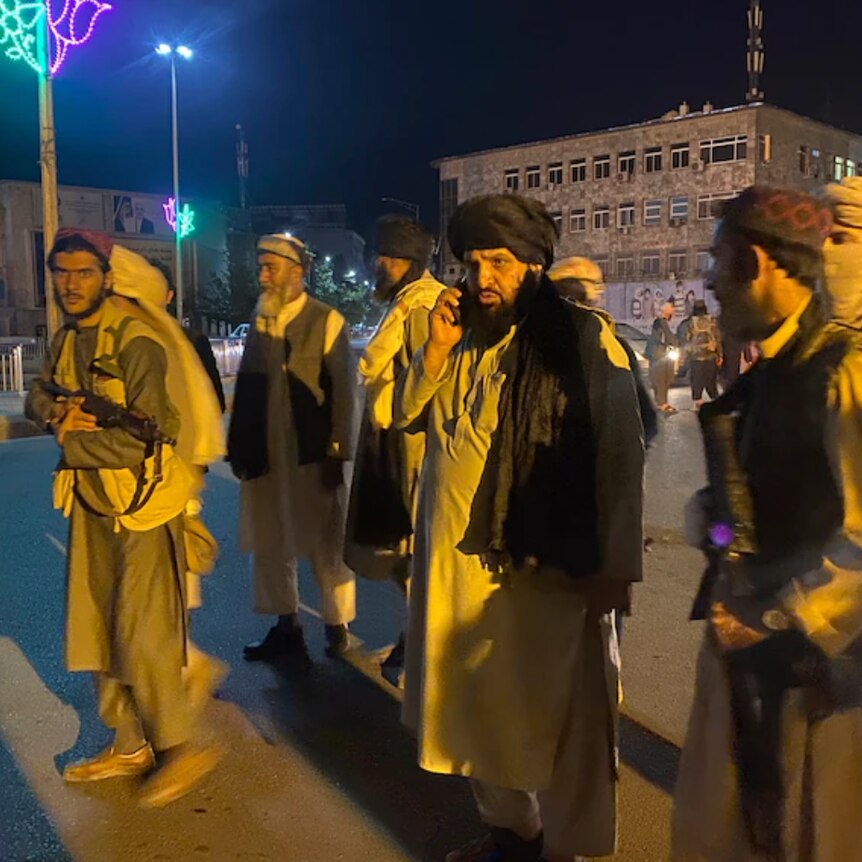 Eight members of the Taliban walk Afghanistan's streets after capturing most of the country's major cities in less than a week.