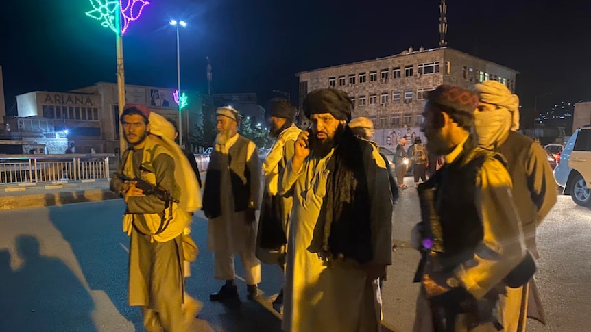 Eight members of the Taliban walk Afghanistan's streets after capturing most of the country's major cities in less than a week.