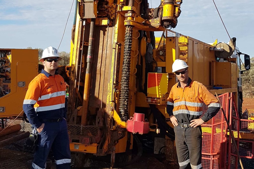 Geologist with driller on mine site