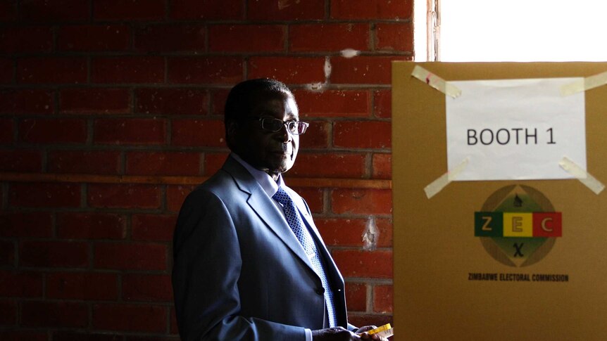 Zimbabwe's president Robert Mugabe prepares to cast his vote in Highfields, outside Harare.