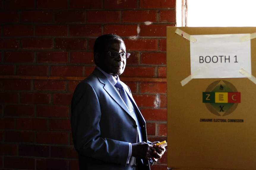 Zimbabwe's president Robert Mugabe prepares to cast his vote in Highfields, outside Harare.