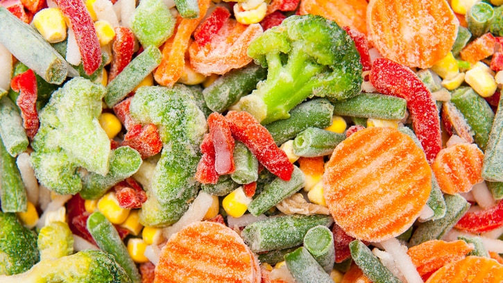 Close-ups of pieces of colourful frozen vegetables