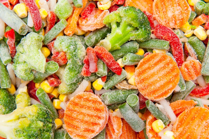Close-ups of pieces of colourful frozen vegetables