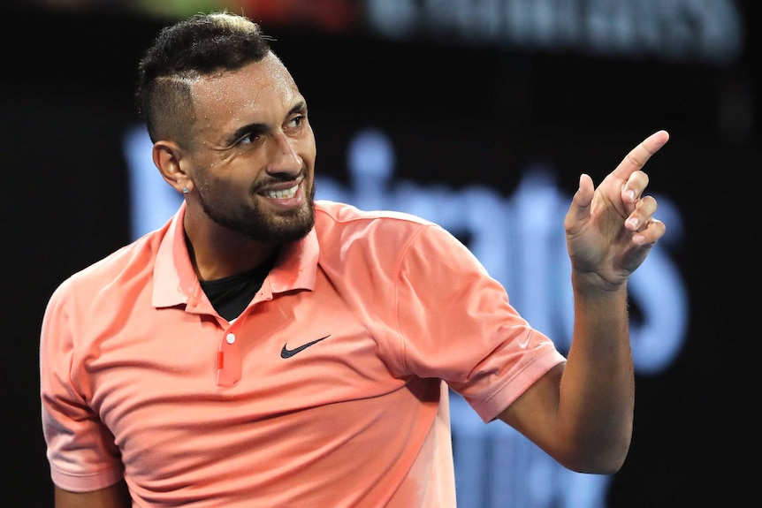 Nick Kyrgios points during a first-round Australian Open game.