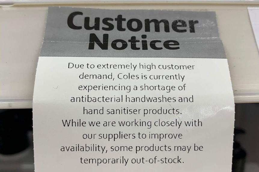 A notice in Coles supermarket saying there is a shortage of antibacterial and sanitiser products